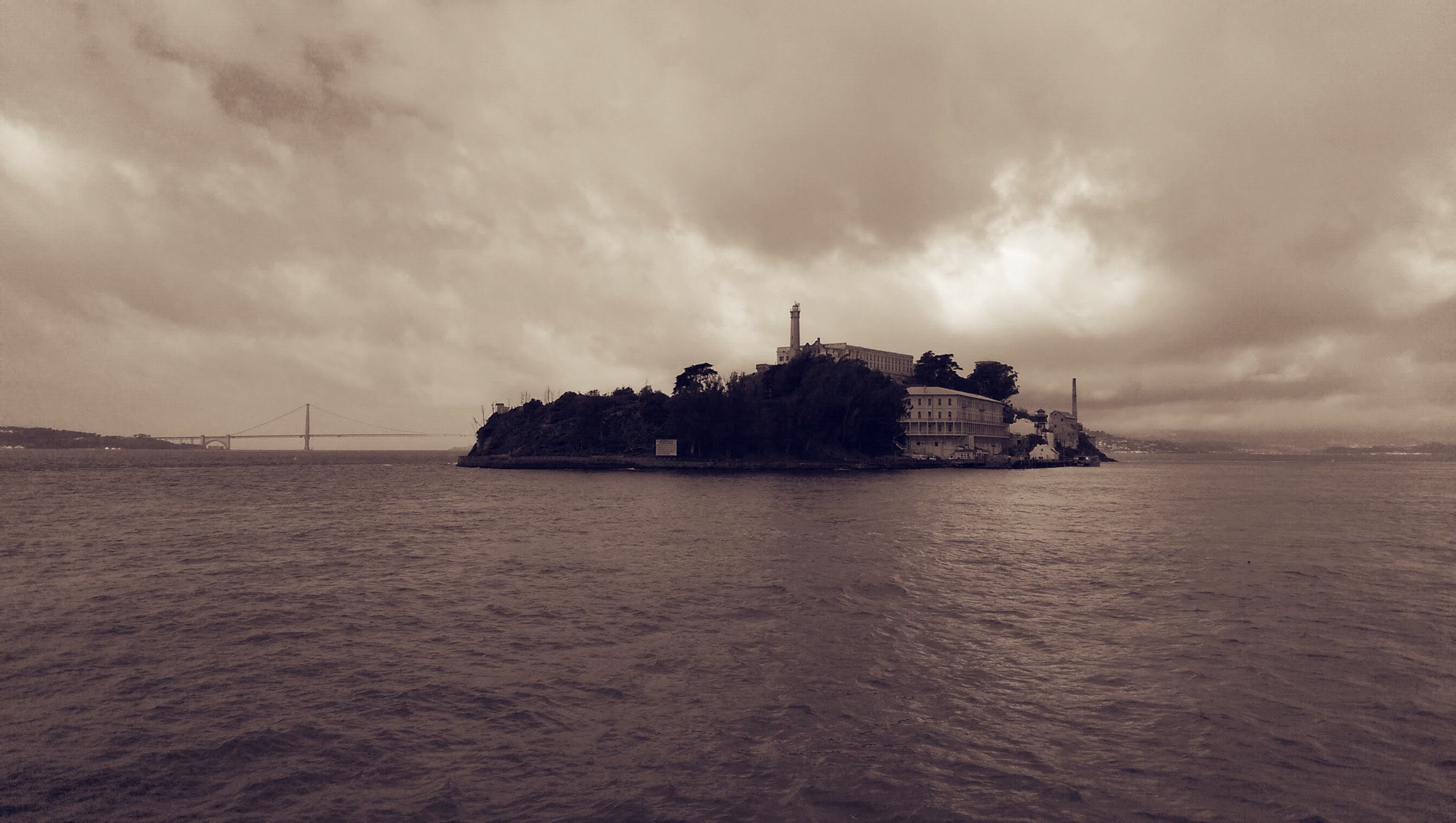 Alcatraz island showing Alcatraz Prison with view coming in by boat 